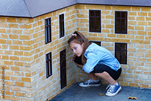 girl plays in a city Park with miniature houses