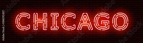 Glowing neon sign with the inscription of the USA city of Chicago. In red and orange colors. Against a brick wall. All elements are isolated.