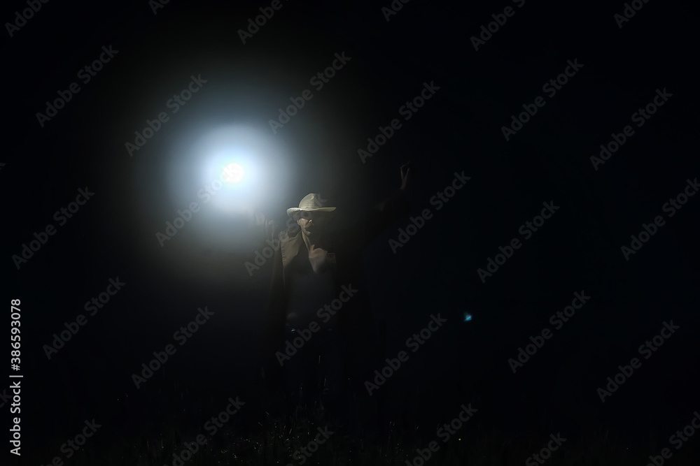 horror in the fog, man with a lantern in the field, landscape halloween holiday, fear concept