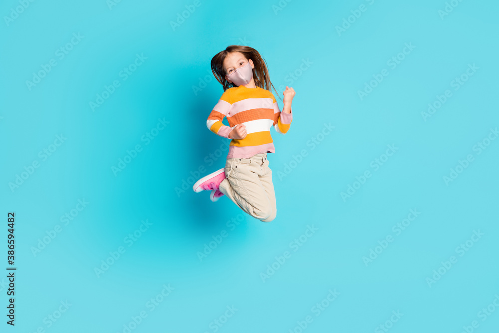 Full length photo of pretty cheerful girl jumping wear mask casual outfit isolated over bright blue color background - obrazy, fototapety, plakaty 