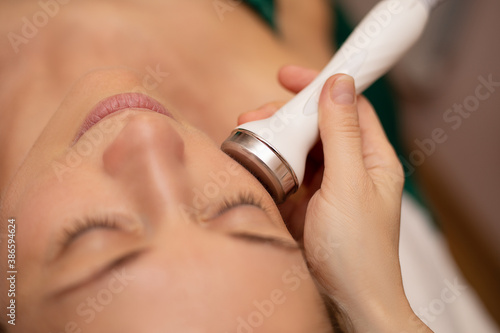 Close-up Of Woman Getting Facial Hydro Microdermabrasion Peeling Treatment At Cosmetic Beauty Spa Clinic. Face Skin Care. Hydra Vacuum Cleaner. Exfoliation, Rejuvenation And Hydratation. Cosmetology. photo