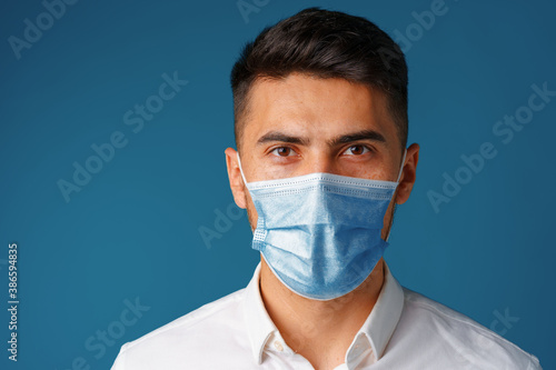 Handsome mixed-race man wearing medical face mask