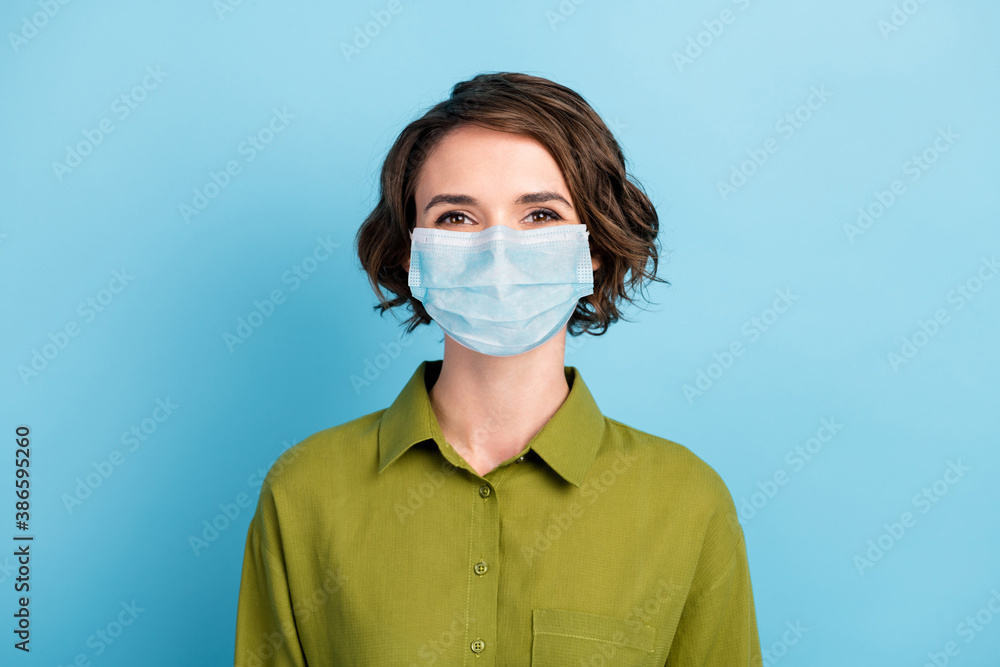 Photo portrait of cute pretty girl with brunette short hair wearing respiratory green shirt isolated on blue color background Photo portrait of cute pretty girl with brunette short hair wearing respiratory green shirt isolated on blue color background