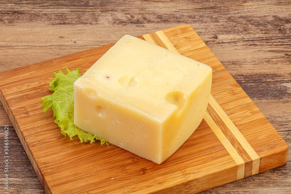 Emmental cheese over wooden board Emmental cheese over wooden board