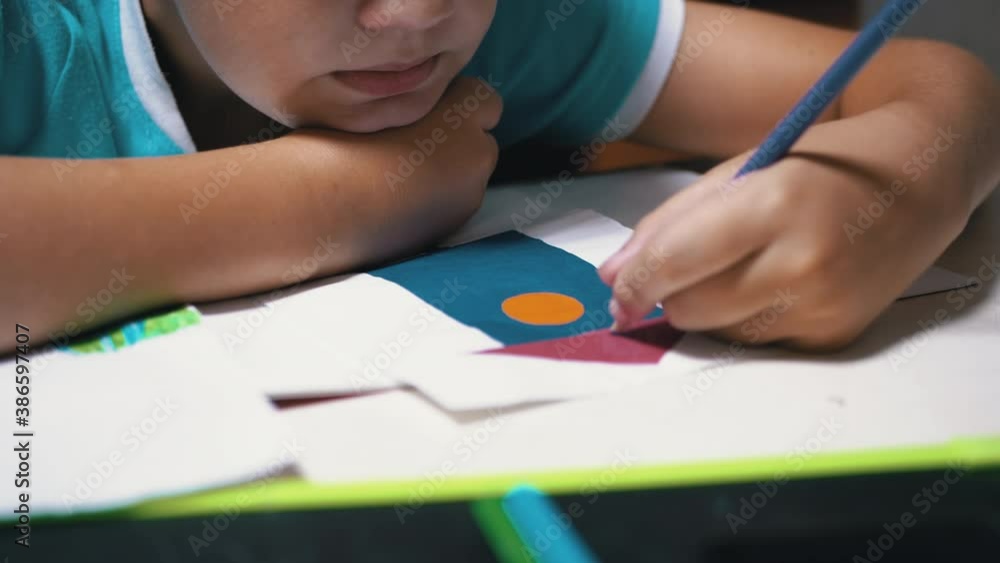 Boy Draws with Colored Pencils at Home. Home Schooling, Education Concept. Boy Draws with Colored Pencils at Home. Home Schooling, Education Concept.