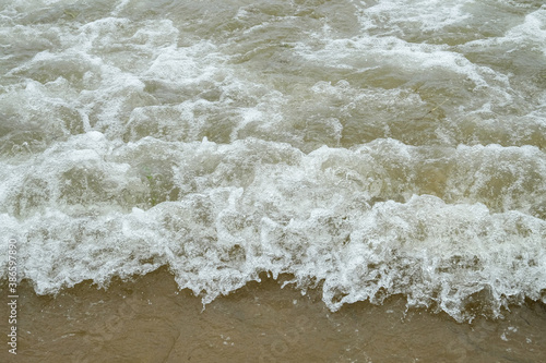 Small waves on the sea coast, foaming waves