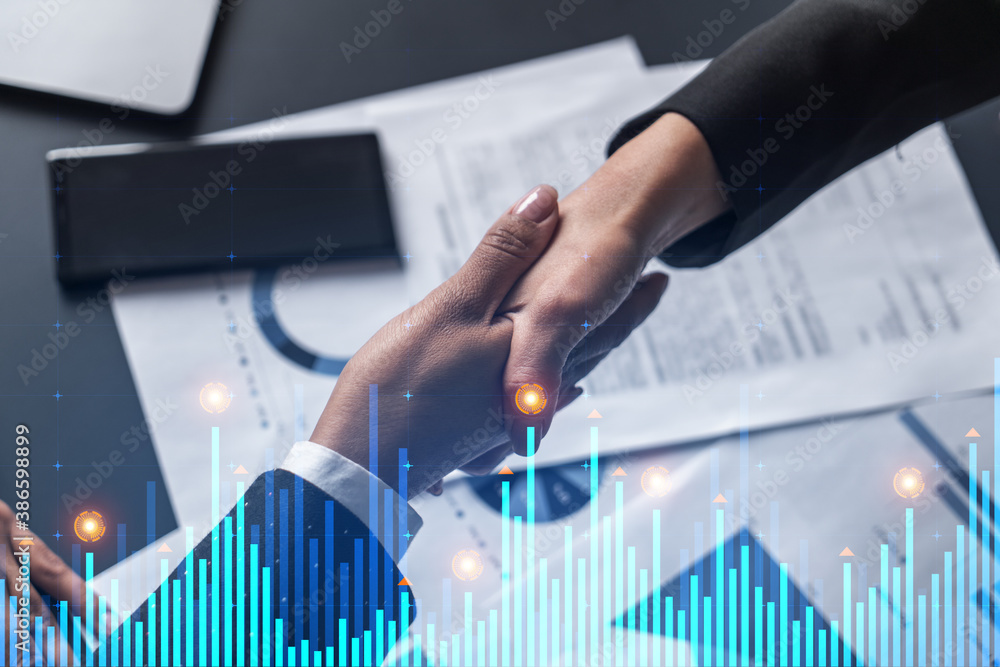 Double exposure of two businesspeople handshake and financial chart hologram drawing background. Concept of partnership in business and data analysis. Formal wear. Double exposure of two businesspeople handshake and financial chart hologram drawing background. Concept of partnership in business and data analysis. Formal wear.