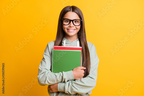 Photo of school person smile arms hold book wear glasses isolated on bright yellow color background