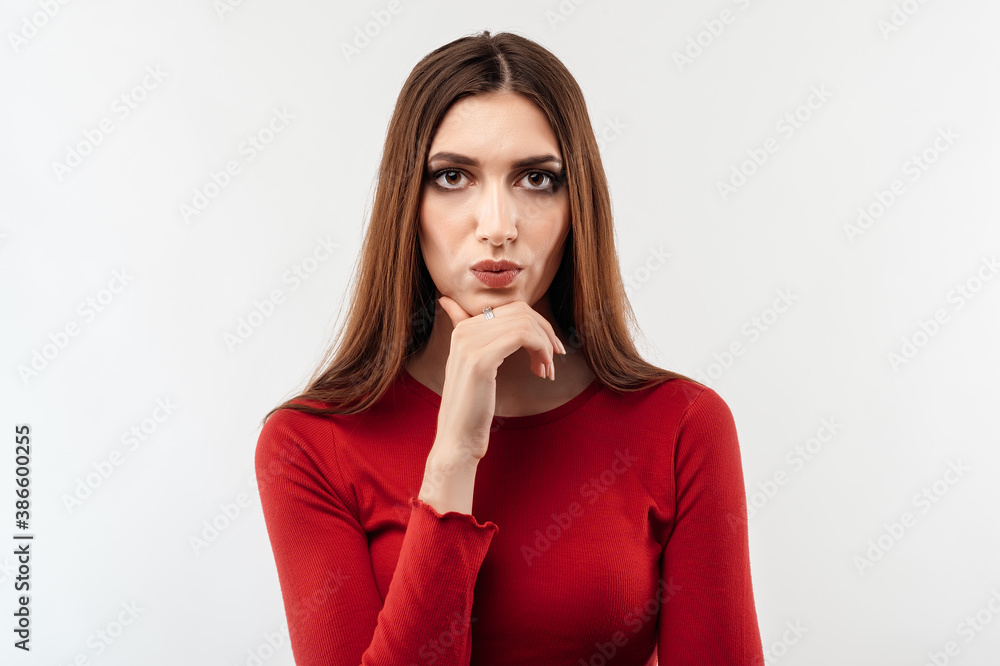 Image of nice serious woman thinking and looking at camera. Human emotions, facial expression concept Image of nice serious woman thinking and looking at camera. Human emotions, facial expression concept