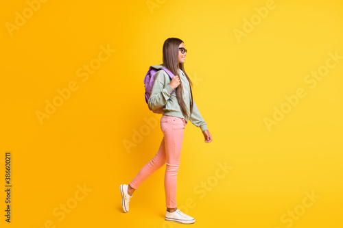 Full length portrait of young person go carry backpack wear hoodie isolated on vibrant yellow color background