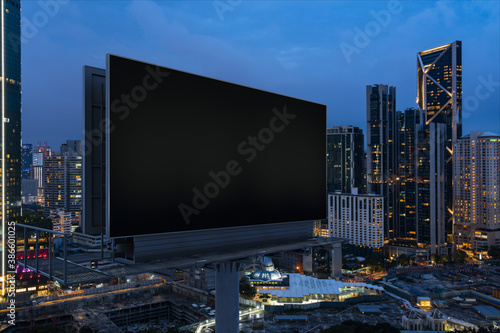 Canvas Print Blank black road billboard with KL cityscape background at night time