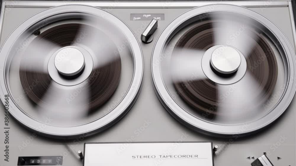 Tape reels rotating of retro tape recorder. Vintage music player close