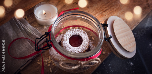 Homemade traditional linzer cookies Homemade traditional linzer cookies with strawberry jam. Atmospheric christmas still life with golden bokeh and space for text. Top view.
