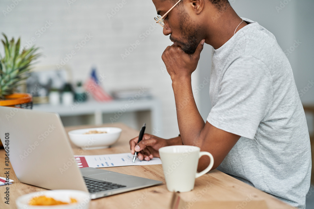 Side view of black man voting from home Side view of black man voting from home