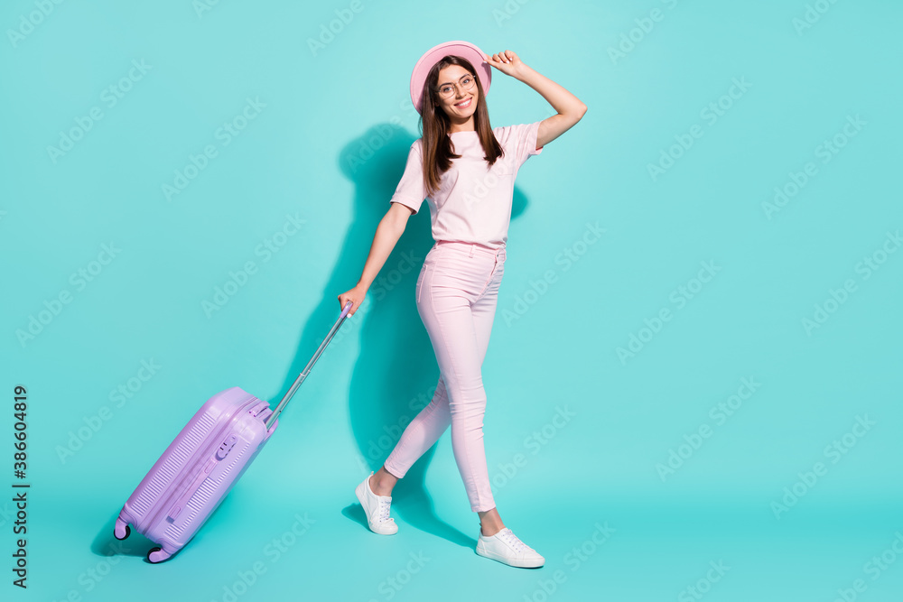 Full length body size view of her she nice-looking attractive pretty slim fit cheerful girl going carrying bag touching hat summer isolated bright vivid shine vibrant green turquoise color background Full length body size view of her she nice-looking attractive pretty slim fit cheerful girl going carrying bag touching hat summer isolated bright vivid shine vibrant green turquoise color background