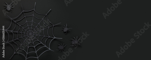 Halloween web banner. Spider web and spiders made of paper on an black background. Top view. Copy space