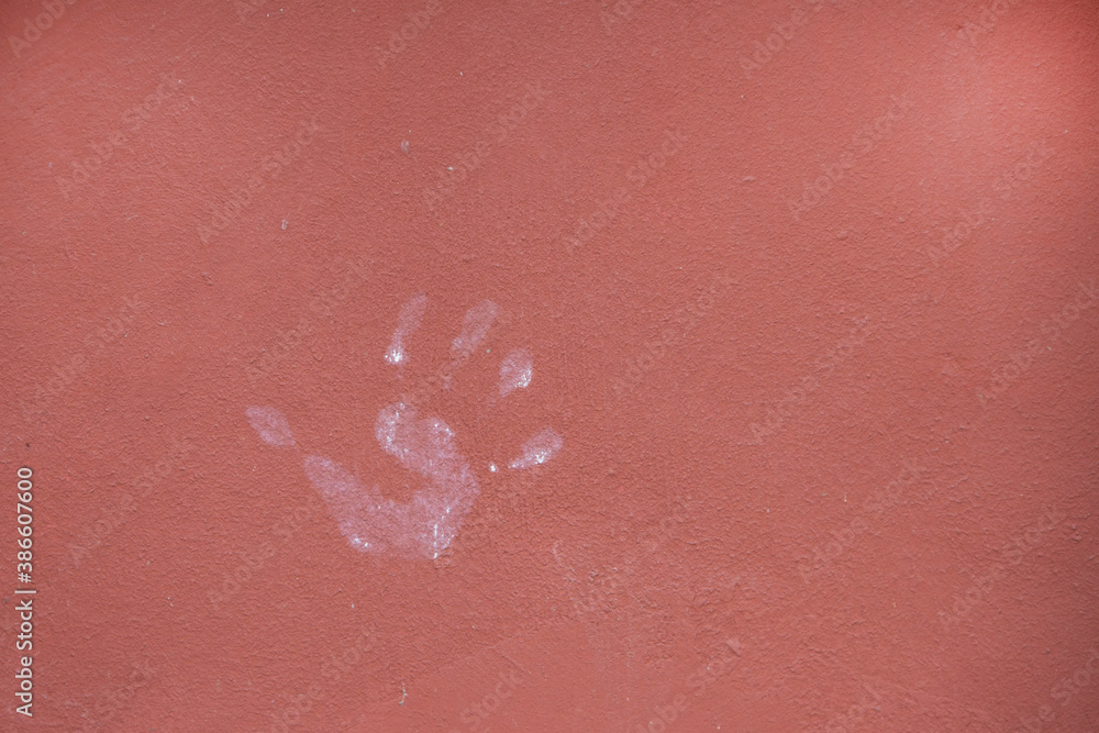Fototapeta premium Palm print on a smooth painted wall.