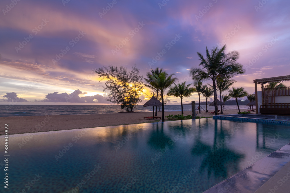 Beautiful sunset on the swimming pool with seaview