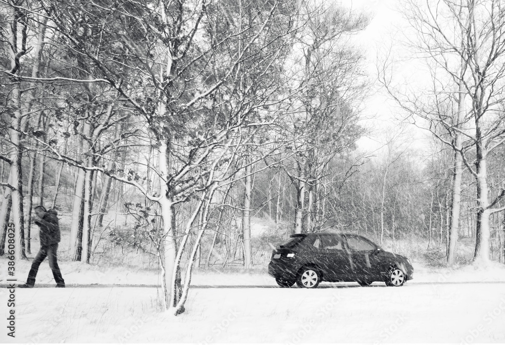 Lonely man and his car in the winter forest