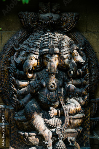 Czech republic - August 15, 2020. Wooden Ganesh in shadow with shaft sun ray