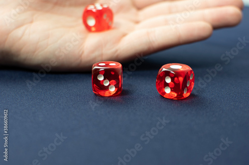 Red dice with white numbers on a blue background