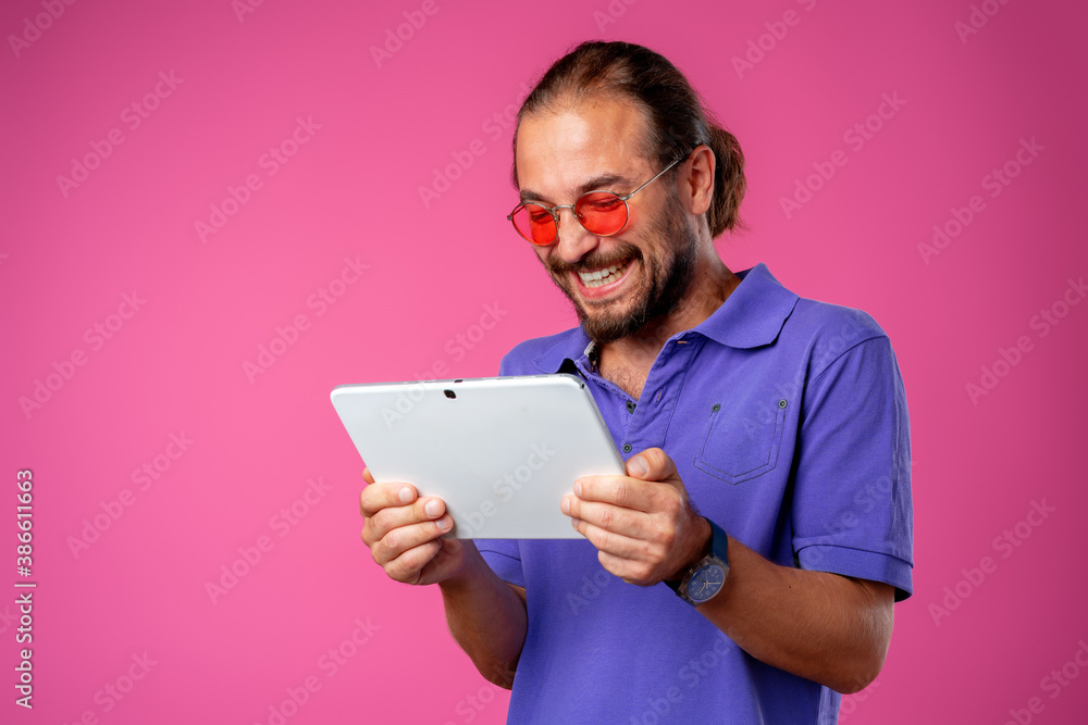 Funny hipster man using his digital tablet Funny hipster man using his digital tablet