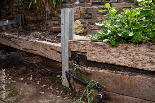 Broken Retaining Wall, rotted and termite damaged wooden sleepers that need to be replaced.