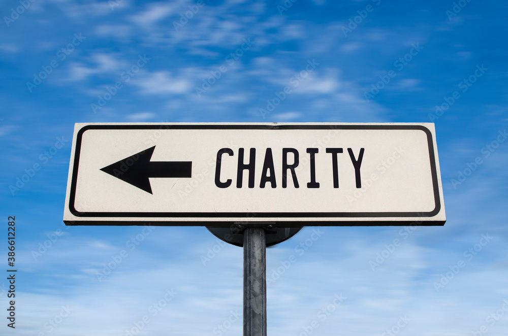 Charity road sign, arrow on blue sky background. One way blank road sign with copy space. Arrow on a pole pointing in one direction. Charity road sign, arrow on blue sky background. One way blank road sign with copy space. Arrow on a pole pointing in one direction.