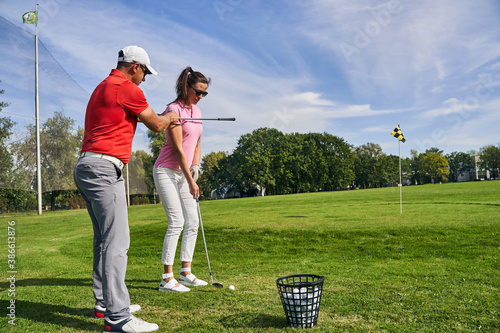 Fotografie Trainer aligning the shoulders of his student beginner