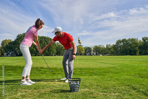 Obraz na plátně Beginner female golfer learning a proper golf grip