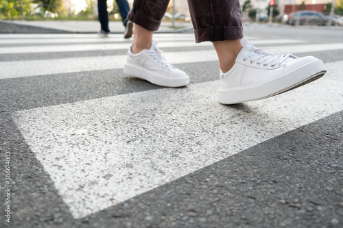 female feet crossing the crosswalk 