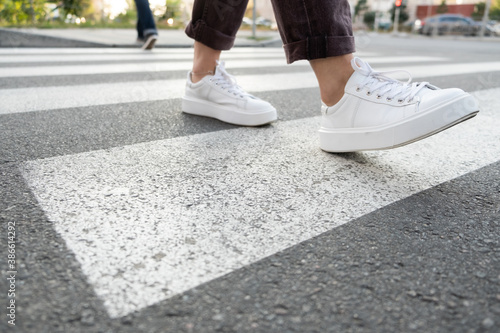 female feet crossing the crosswalk 