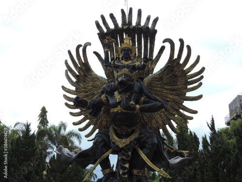 golden Garuda statue in the garden. nature photo object