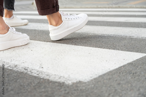 female feet crossing the crosswalk 