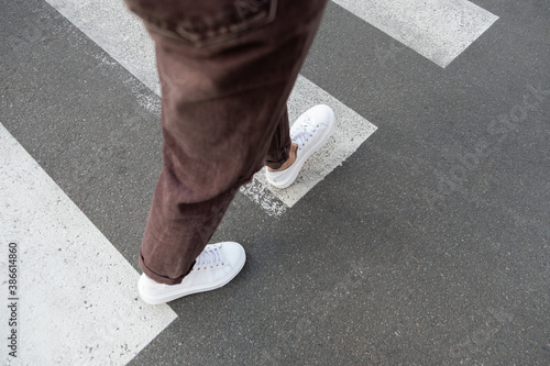 female feet crossing the crosswalk 