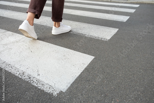 female feet crossing the crosswalk
