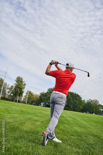Fit adult Caucasian player improving his swing