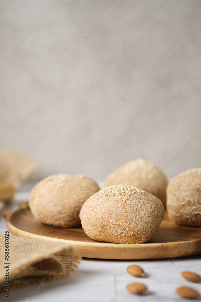 Gluten free Keto bread. Homemade ketogenic buns with sesame seeds. set on white cafe table. Gluten free Keto bread. Homemade ketogenic buns with sesame seeds. set on white cafe table.