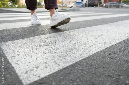 female feet crossing the crosswalk
