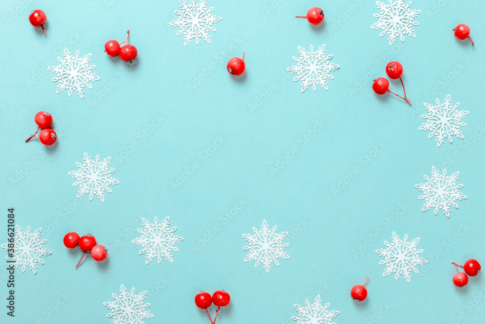 Christmas sale. Red berry, white snowflakes in shape frame on pastel blue background for greeting card. Xmas backdrop with space for text. Christmas sale. Red berry, white snowflakes in shape frame on pastel blue background for greeting card. Xmas backdrop with space for text.