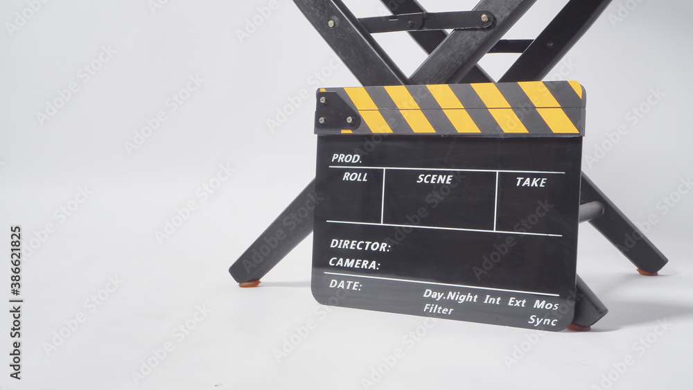 Naklejka premium Director chair with black and yellow clapper board or movie slate on white background.it is used in video production and film industry.
