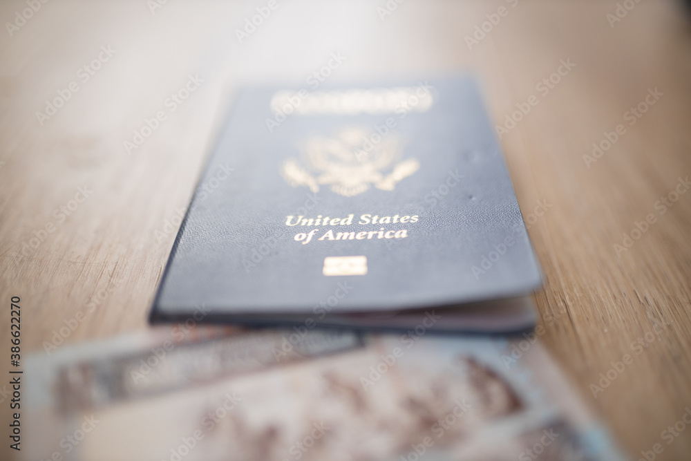 United States of America Passport with a Kuwait Quarter Dinar Partially Inside United States of America Passport with a Kuwait Quarter Dinar Partially Inside