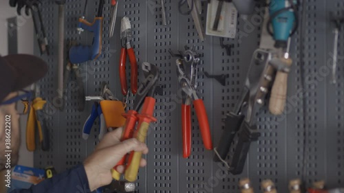 Man chooses a tool from his laboratory, bricolage and 