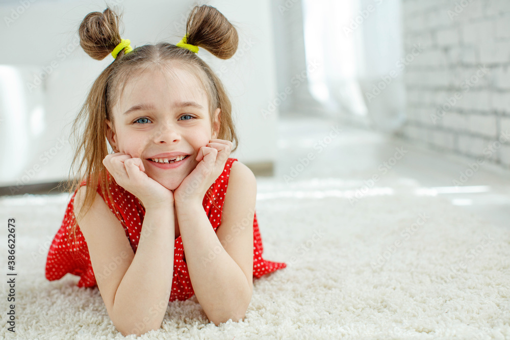 A beautiful little girl lost the first milk tooth. Loss of primary teeth, replacement of teeth with permanent ones. Children's dentistry. Beautiful child teeth. High quality photo. A beautiful little girl lost the first milk tooth. Loss of primary teeth, replacement of teeth with permanent ones. Children's dentistry. Beautiful child teeth. High quality photo.
