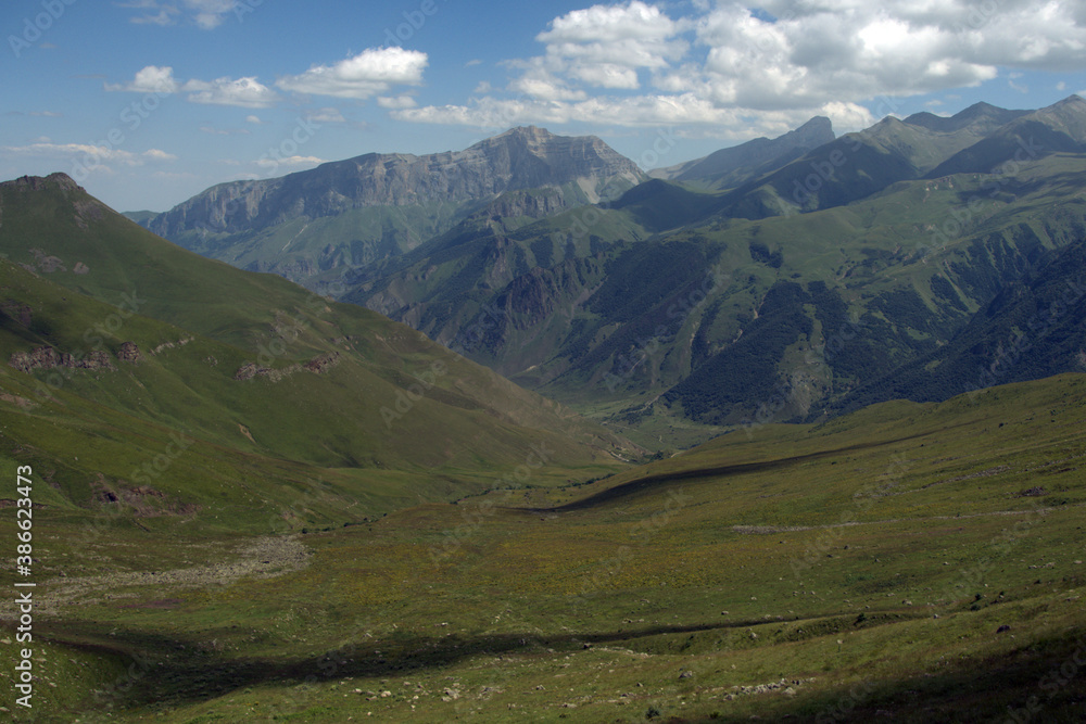 Alpine landscape with mountain peaks and green valleys. Caucasus, Russia. 