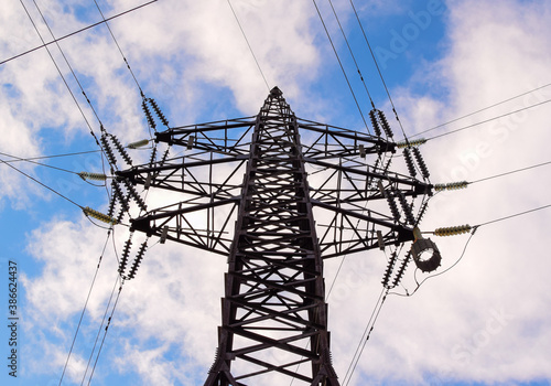 Power transmission tower against the sky. Bottom view. Electric power for transfer power by electrical grids. High voltage electric.