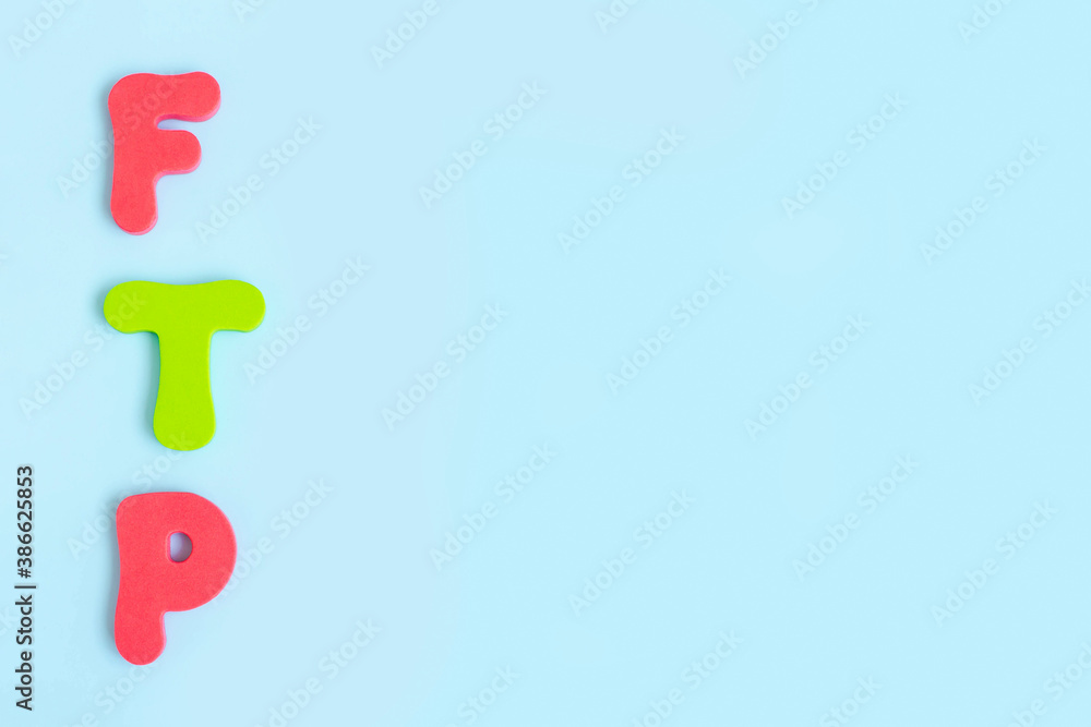 File Transfer Protocol. Word ftp on blue background. Flat lay, top view. Copy space. File Transfer Protocol. Word ftp on blue background. Flat lay, top view. Copy space.