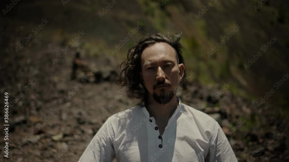Asian guy playing Tibedt singing copper cups on a viewing mountain Asian guy playing Tibedt singing copper cups on a viewing mountain