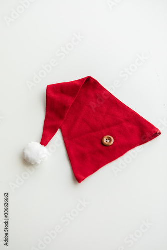 Combed cotton clothes and newborn hats of various colors and types on a white background.