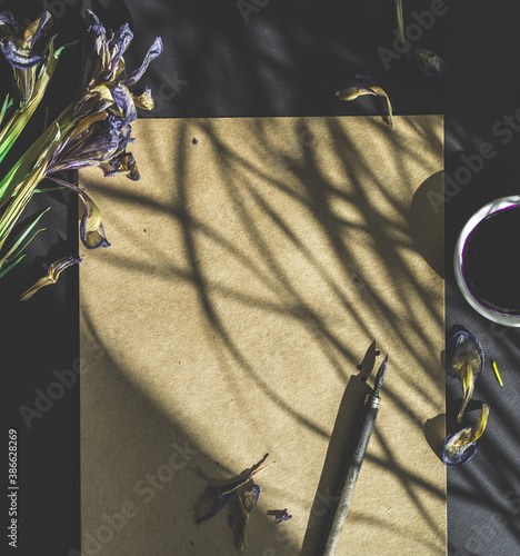 flowers, pen and craft paper on a black background